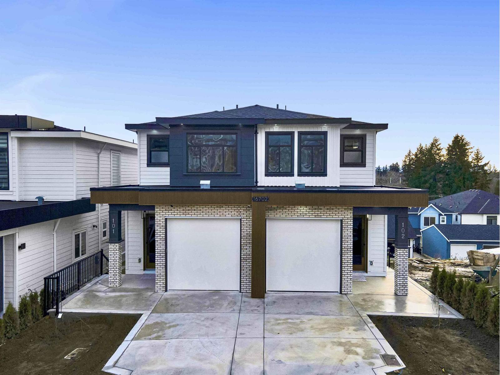 A modern two-story house with a garage.