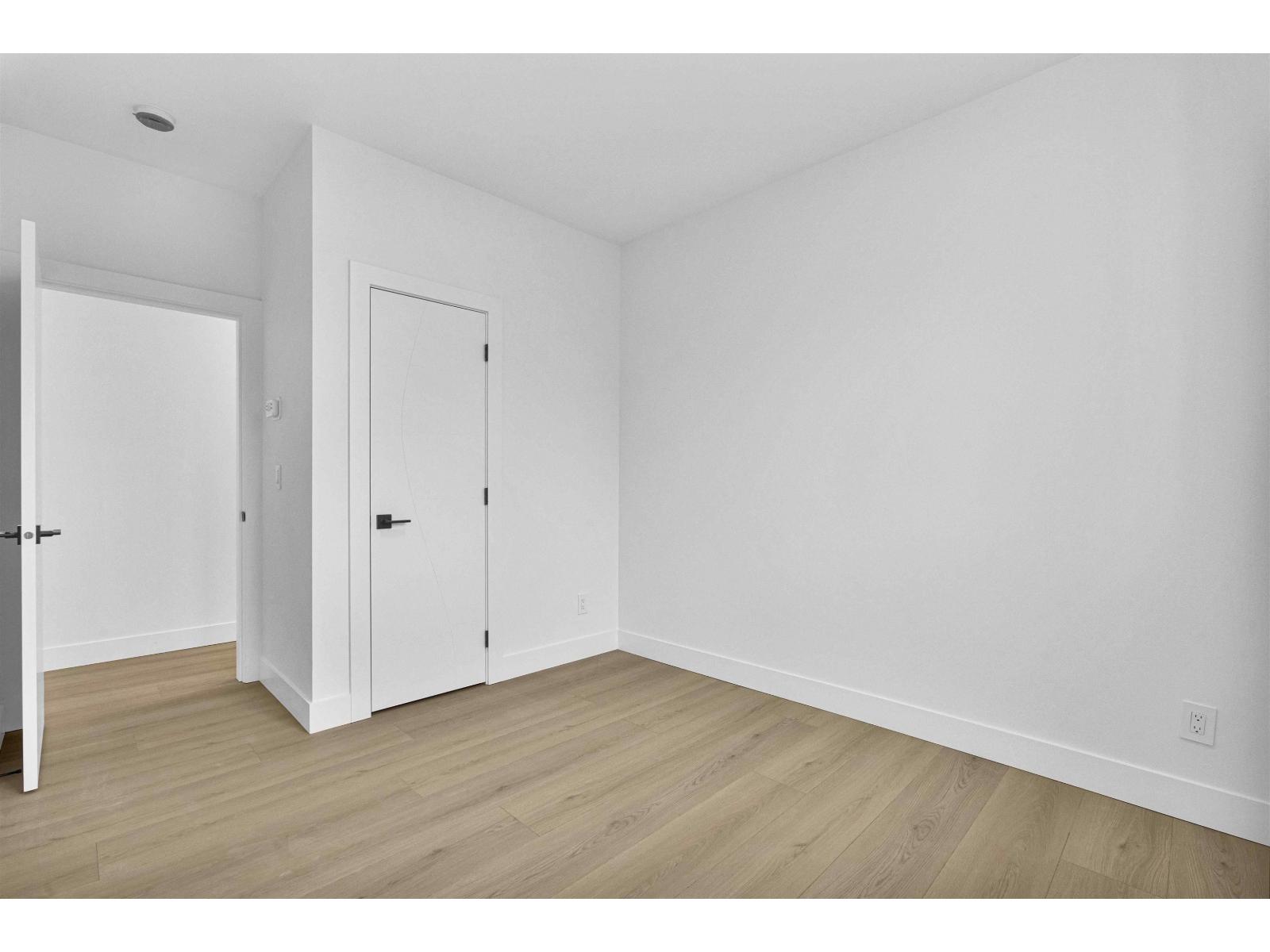 A room with two doors and a wooden floor.