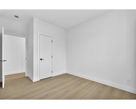 A room with two doors and a wooden floor.