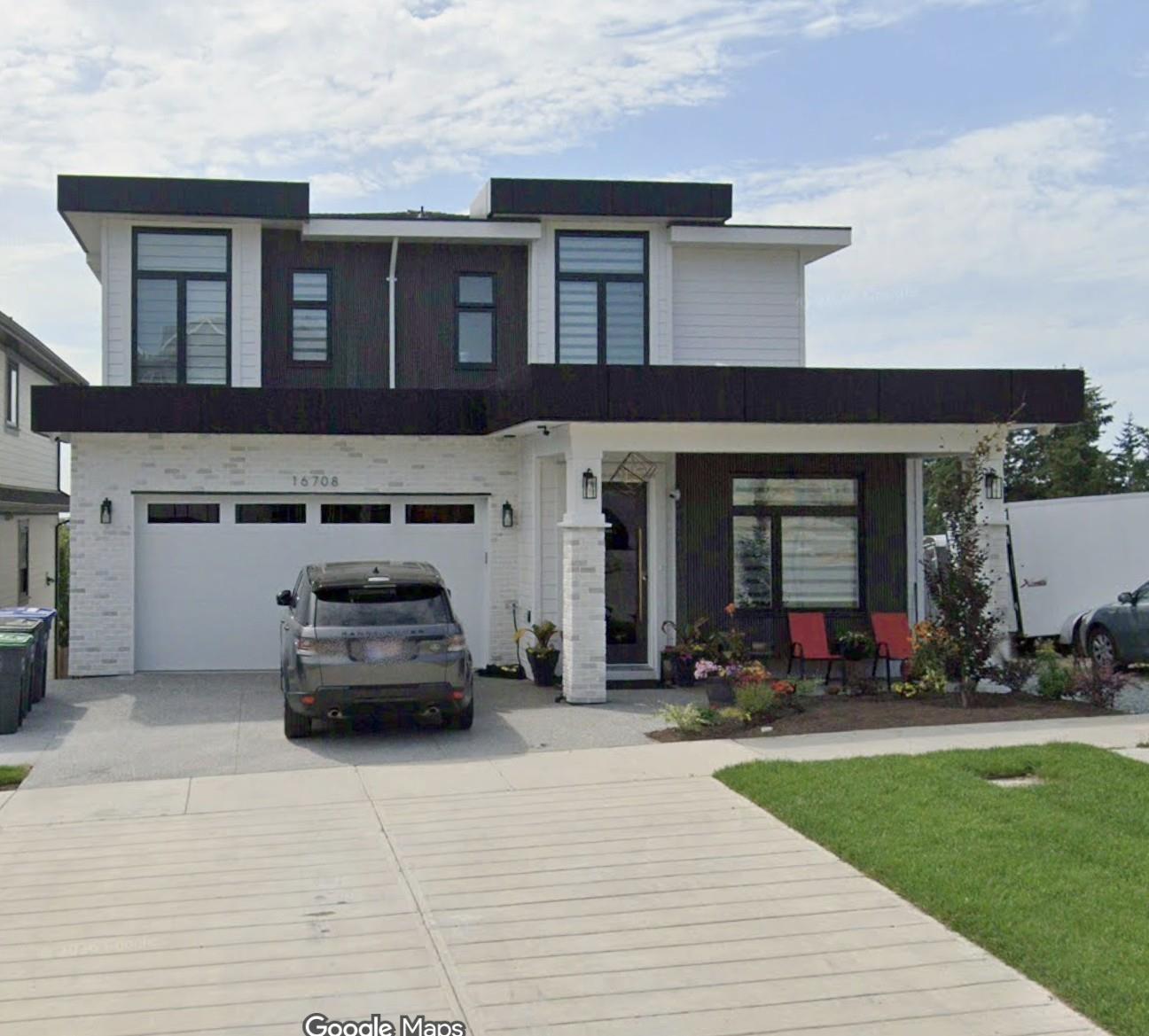 A modern two-story house with a garage and a car parked in front.