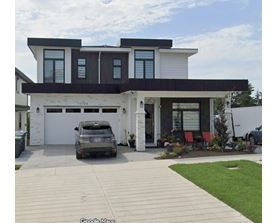 A modern two-story house with a garage and a car parked in front.