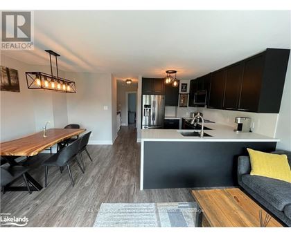 A modern kitchen with a dining table and chairs.