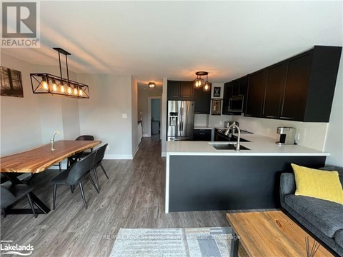 A modern kitchen with a dining table and chairs.
