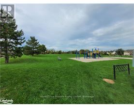 A playground with a slide and swings in a grassy area.