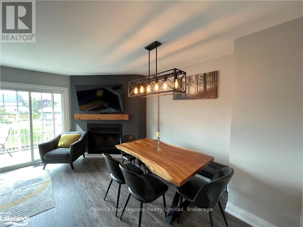 A dining room with a wooden table and chairs.