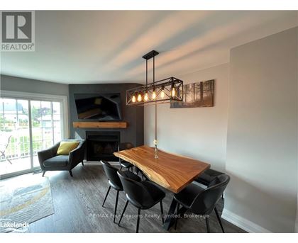 A dining room with a wooden table and chairs.