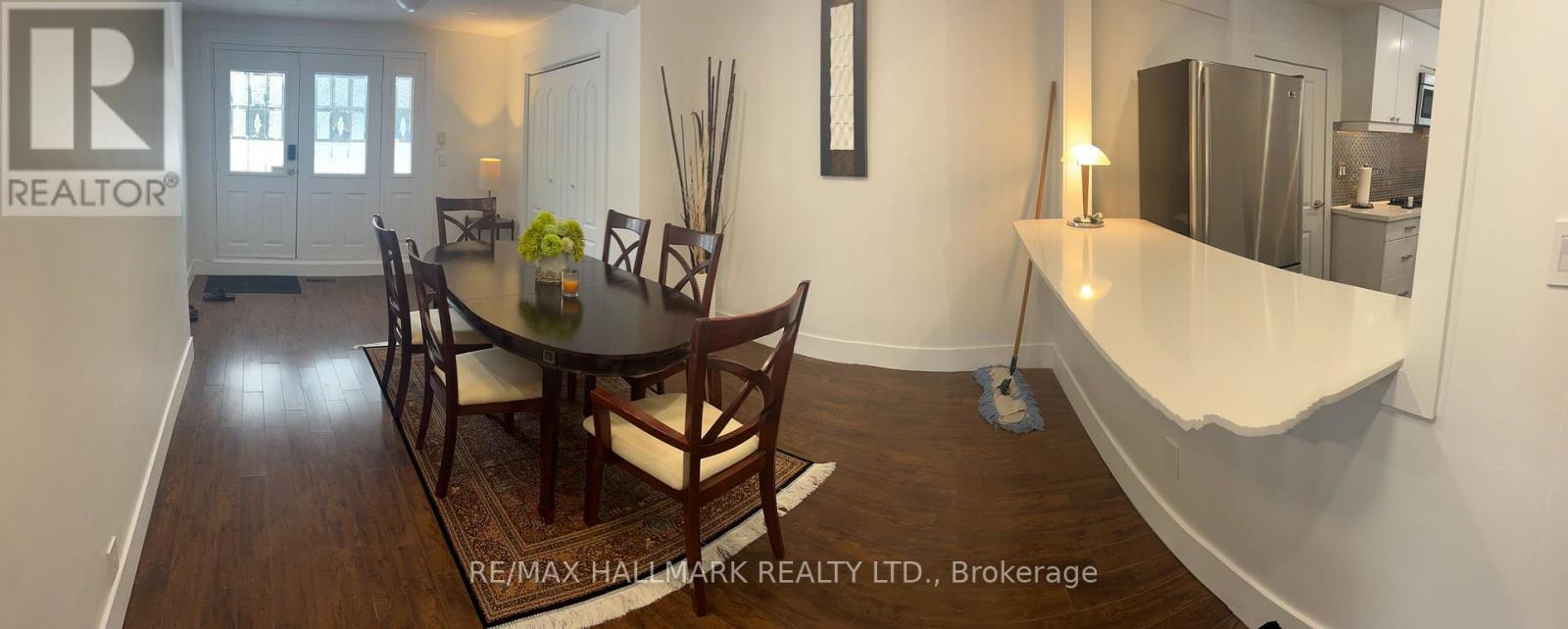 A dining room with a table set for four.