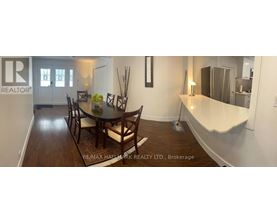 A dining room with a table set for four.