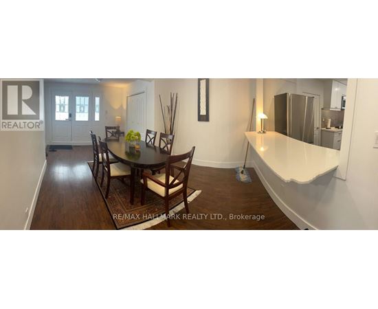 A dining room with a table set for four.