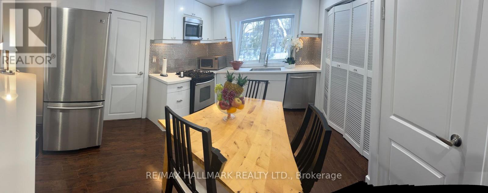 A kitchen with a table and chairs in the middle of it.
