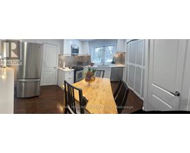 A kitchen with a table and chairs in the middle of it.