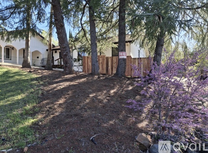 A house with a brown roof and a wooden deck.