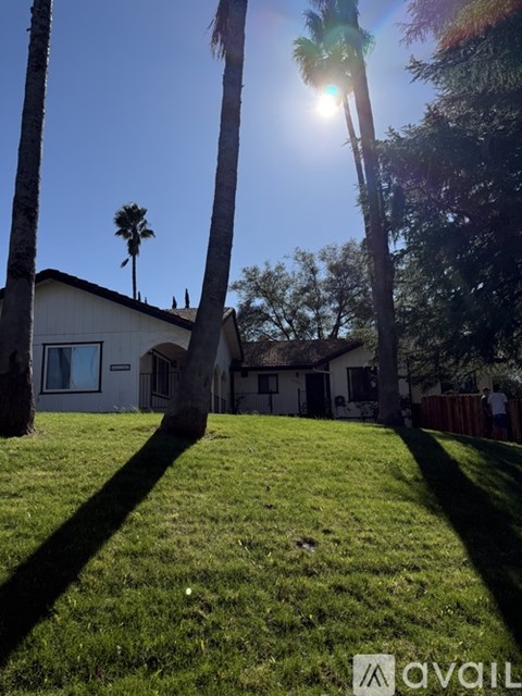 A house with a brown roof and a wooden deck.