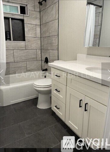 A bathroom with a toilet, sink, and a tub.