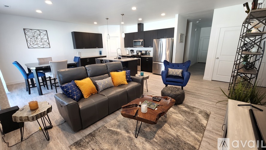 A modern living room with a grey sofa and a wooden coffee table.