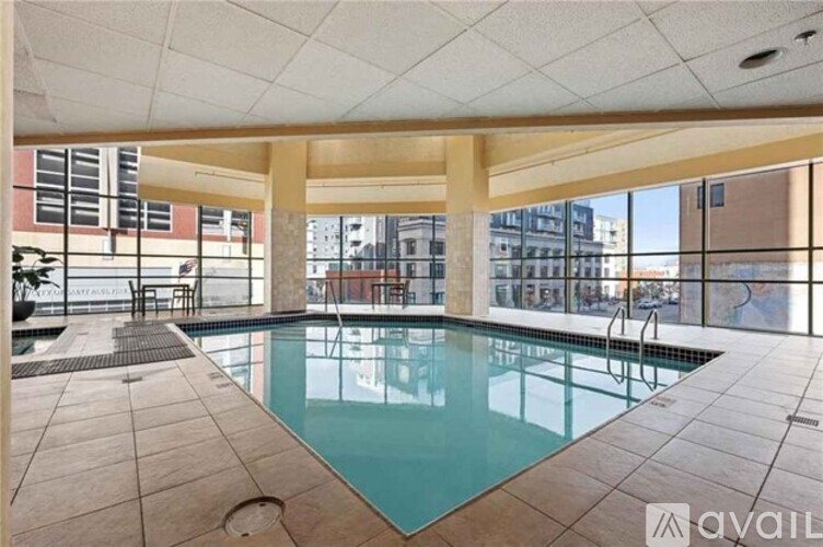 A large indoor swimming pool with a tiled floor and ceiling.