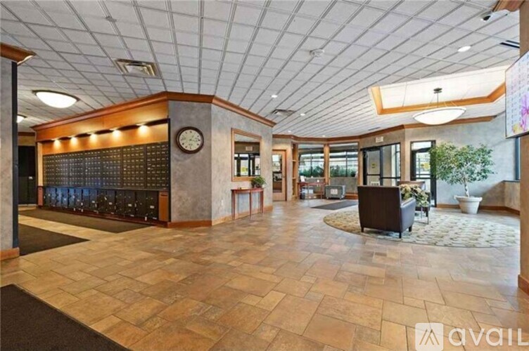 A spacious lobby with a large clock on the wall.