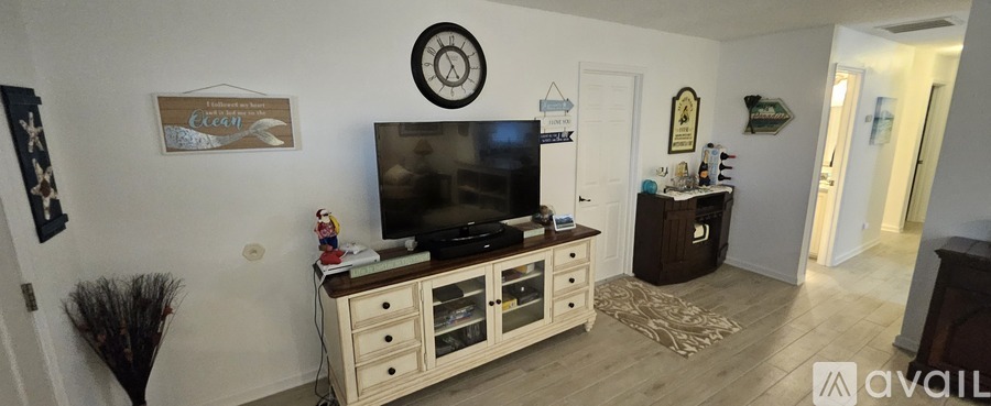 A living room with a television and a cabinet.