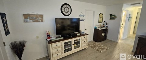 A living room with a television and a cabinet.