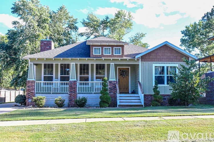 A house with a front porch and a red roof.