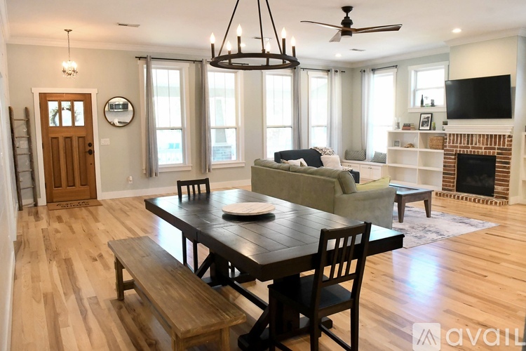 A dining room with a wooden table and chairs.