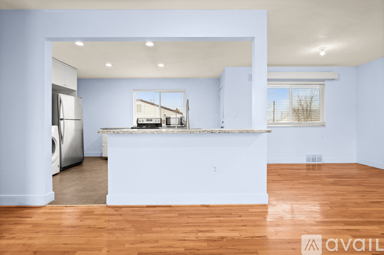 A kitchen with a white counter and a washing machine.