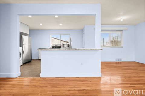 A kitchen with a white counter and a washing machine.