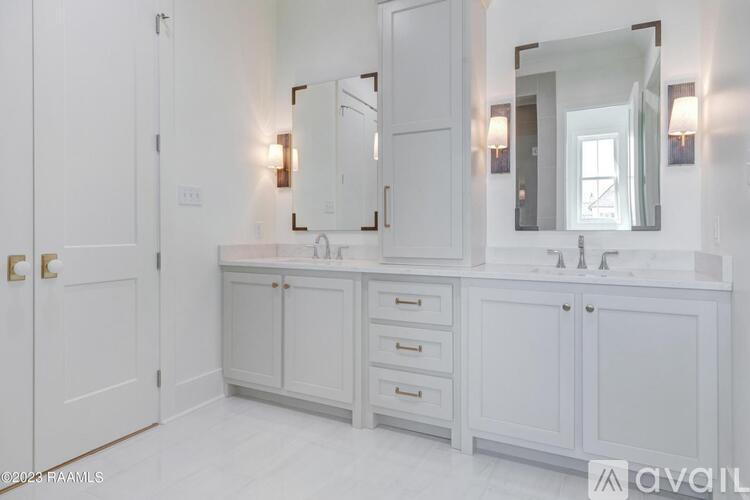 A bathroom with a white vanity and a large mirror.