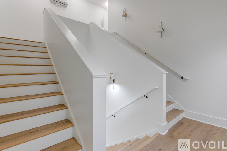 A staircase with wooden steps and white railings.