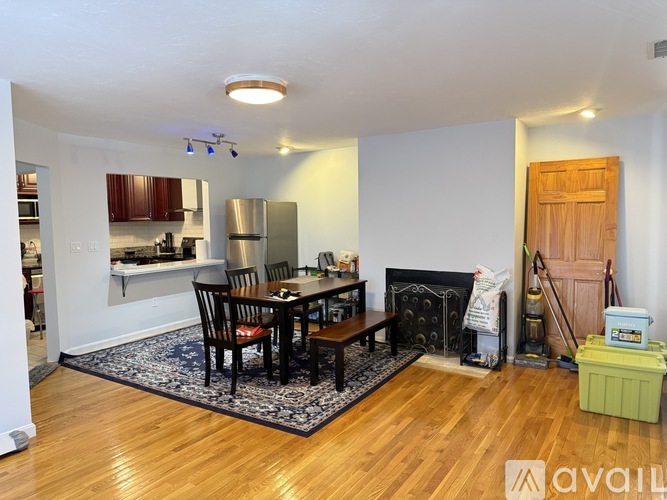 A dining room with a wooden table and chairs.