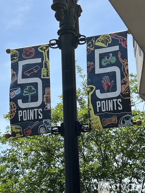 Two signs hanging from a pole that say 5 points.