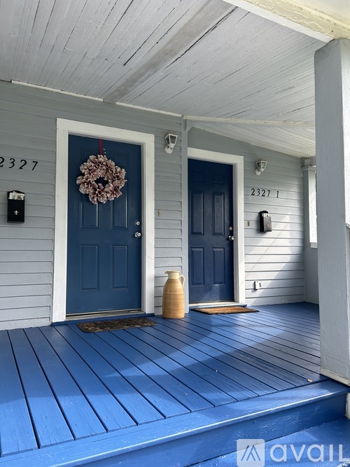 A blue door with a wreath on it.