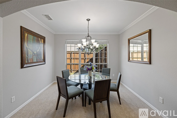 A dining room with a table set for six.