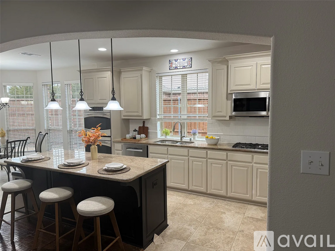 A kitchen with a bar area and a dining table.