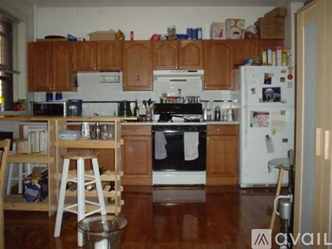 A kitchen with wooden cabinets and a white fridge.