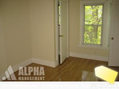 A room with a window and a door is managed by Alpha Management.