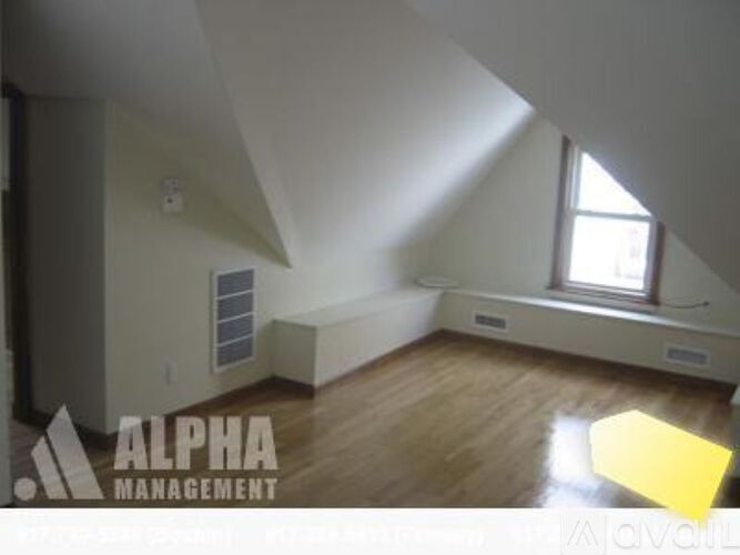 A room with a window and a skylight is available for rent.
