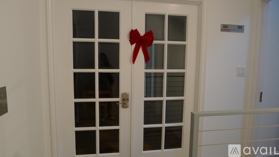 A white door with a red bow on it.