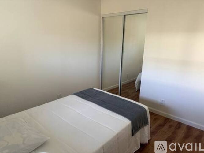 A bedroom with a bed and a door.