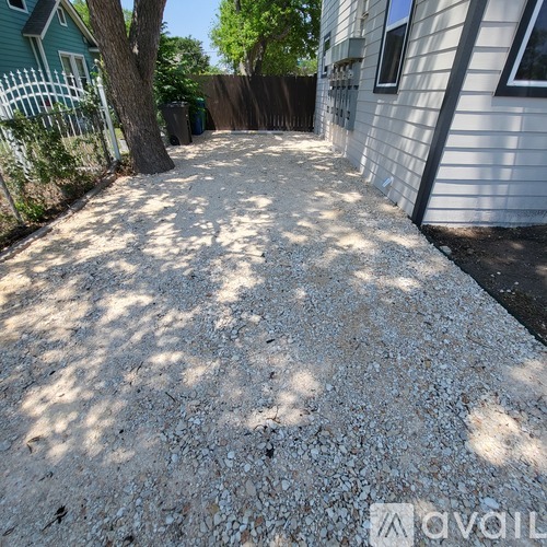 A gravel yard in front of a house.