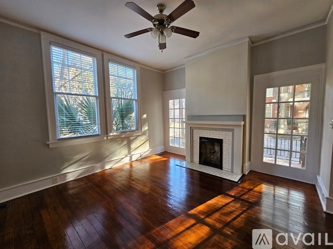 A room with a fireplace and a ceiling fan.