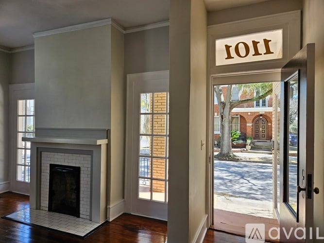 A room with a fireplace and a door with a sign that says "1011".