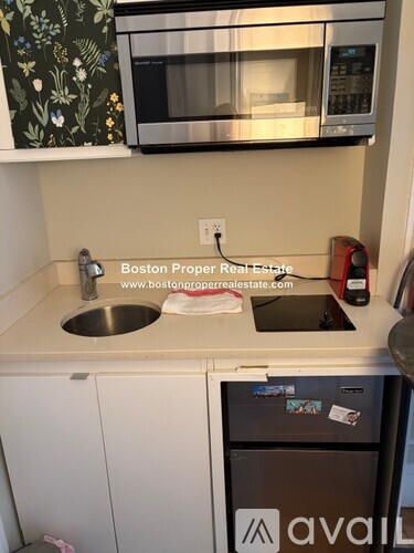 A kitchen with a white door and a white counter.