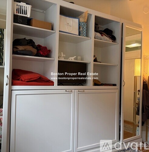 A kitchen with a white stove top oven and a white refrigerator.
