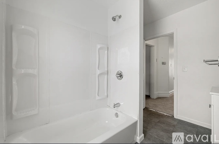 A white bathroom with a tub and a shower.