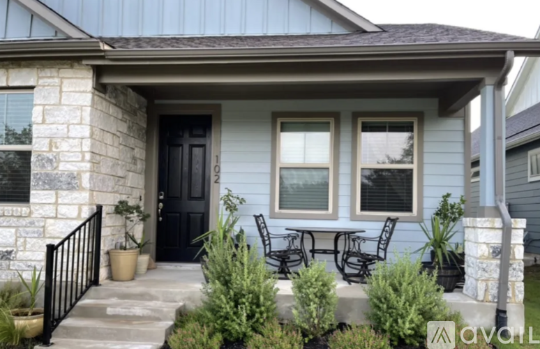 A house with a black door and a small porch.