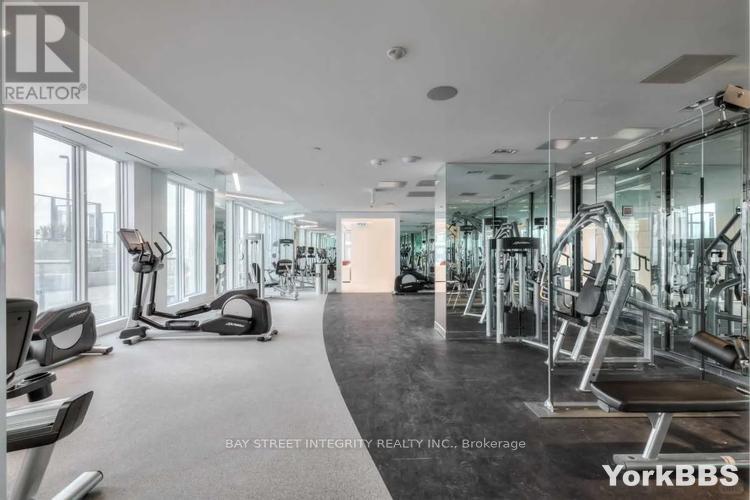 A gym with a variety of equipment including treadmills, weights, and exercise machines.