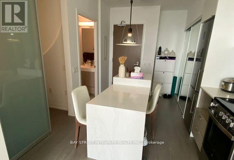 A white dining table with a white chair in a modern kitchen.