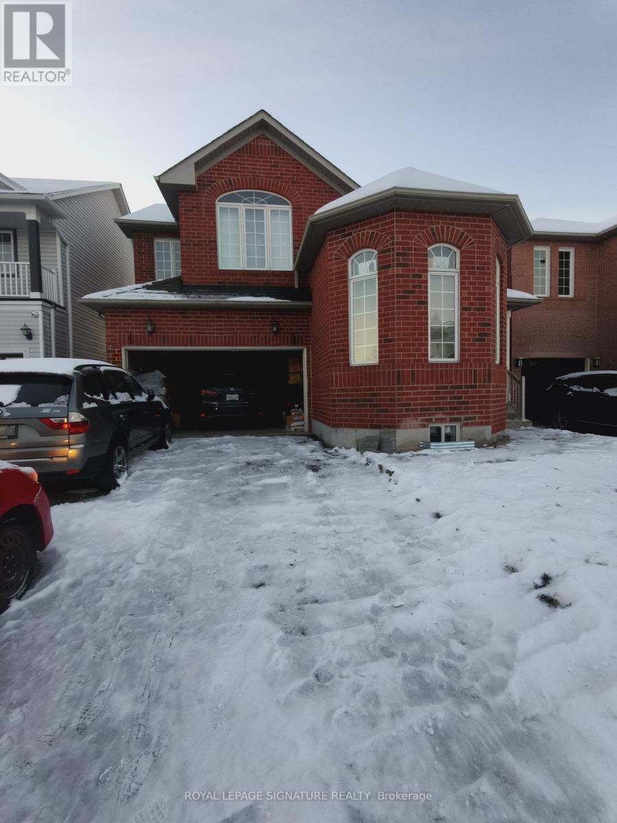 A red brick house with a white garage door and a car parked in front.