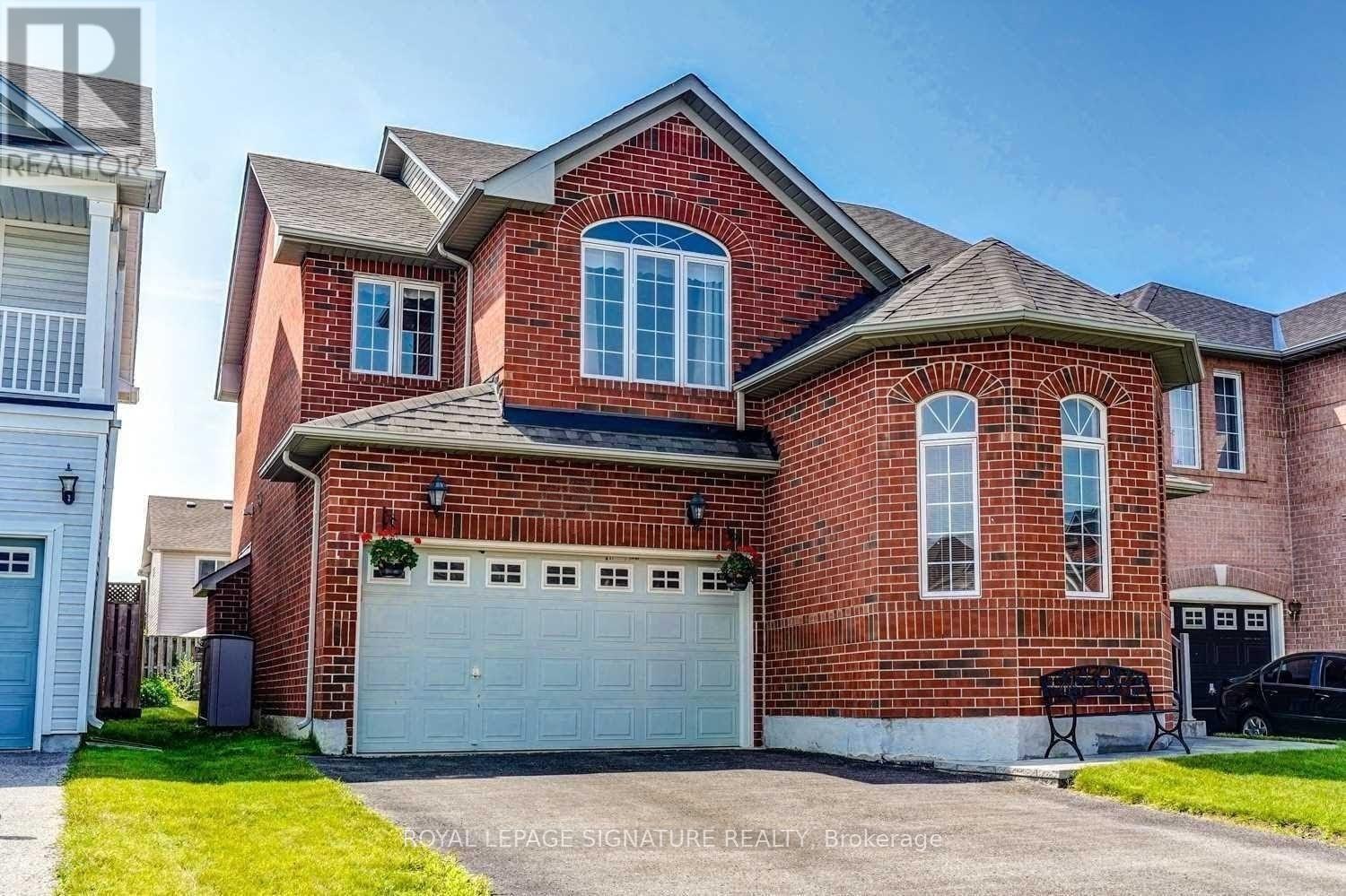A red brick house with a white garage door.